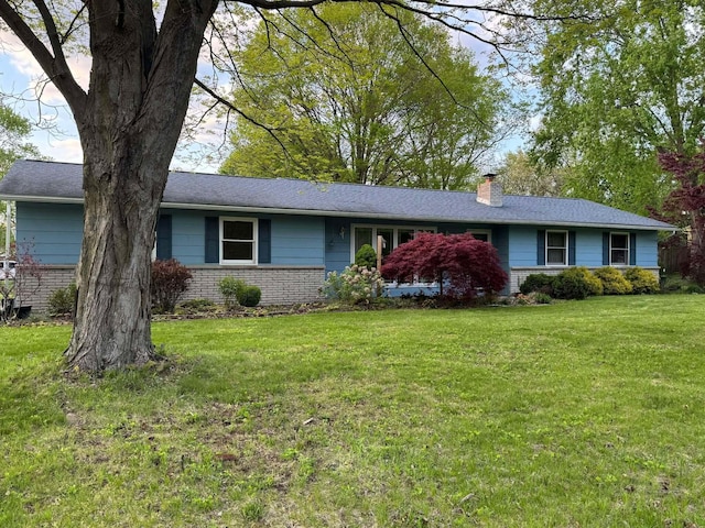 3321 Sandra Dr, Kalamazoo, MI 49004 - ranch-style house with a chimney, a front yard, and brick siding