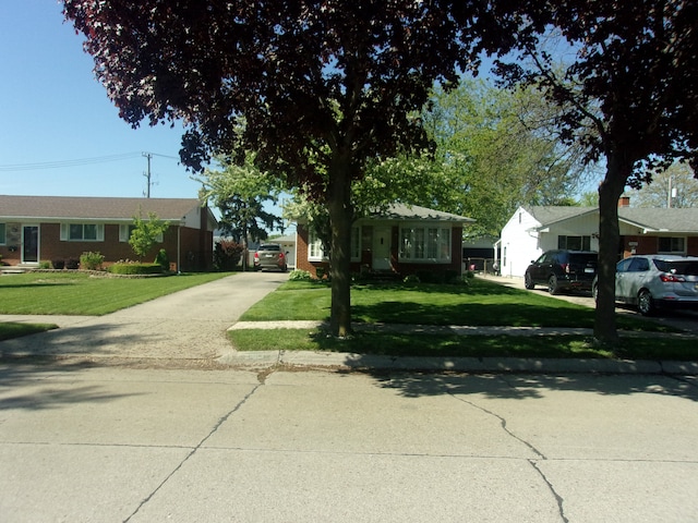 21613 Hoffman St, Saint Clair Shores, MI 48082 - ranch-style home with driveway, a front yard, and brick siding
