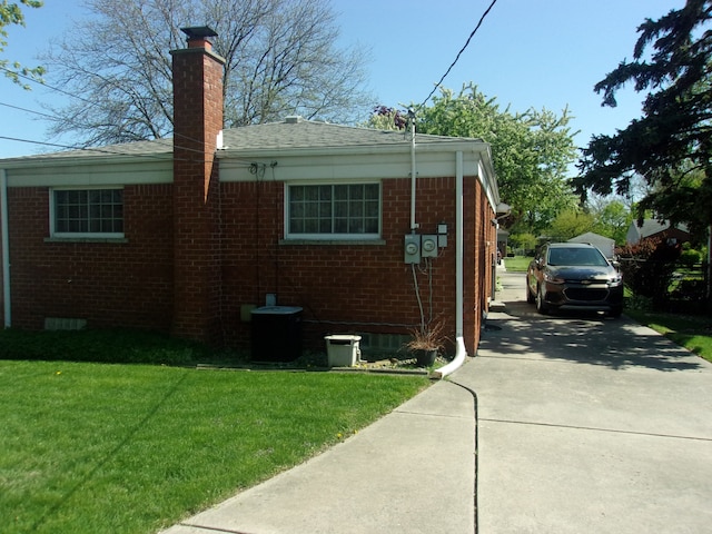 21613 Hoffman St, Saint Clair Shores, MI 48082 - view of property exterior with brick siding, a yard, a chimney, and roof with shingles