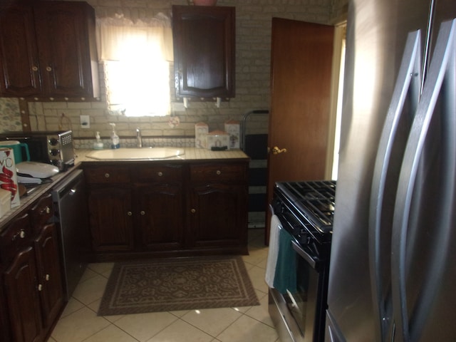 21613 Hoffman St, Saint Clair Shores, MI 48082 - kitchen with appliances with stainless steel finishes, a sink, light tile patterned floors, backsplash, and light countertops