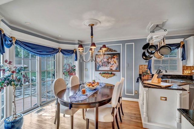 1612 Michael, Clawson, MI 48017 - dining space featuring a chandelier, light wood-type flooring, crown molding, and baseboards