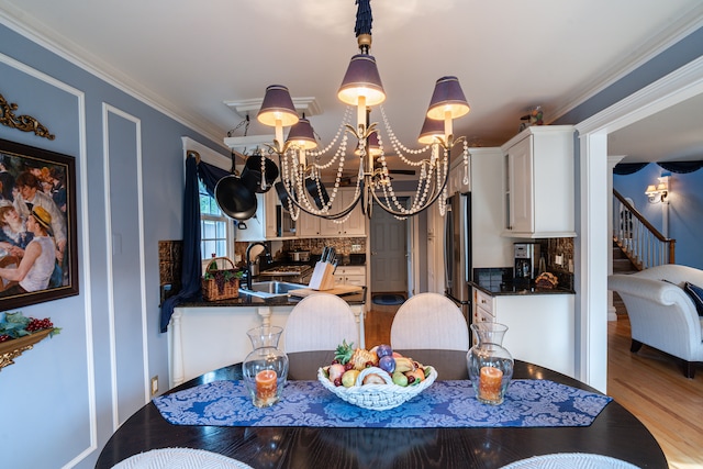 1612 Michael, Clawson, MI 48017 - dining space featuring a chandelier, light wood-style flooring, and ornamental molding