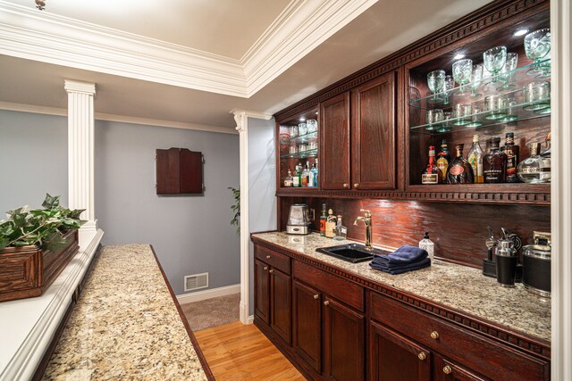 1612 Michael, Clawson, MI 48017 - indoor wet bar with ornate columns, light wood-style floors, decorative backsplash, crown molding, and baseboards