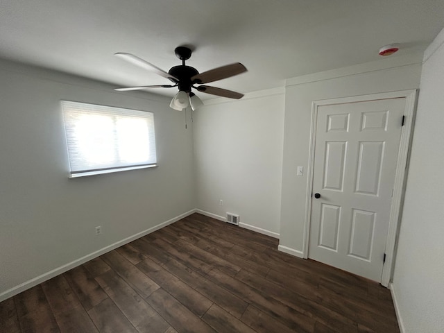 unfurnished room featuring a ceiling fan, dark wood-type flooring, baseboards, and a smoke detector