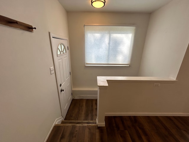 entryway featuring dark wood-style flooring and baseboards