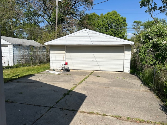 detached garage featuring fence