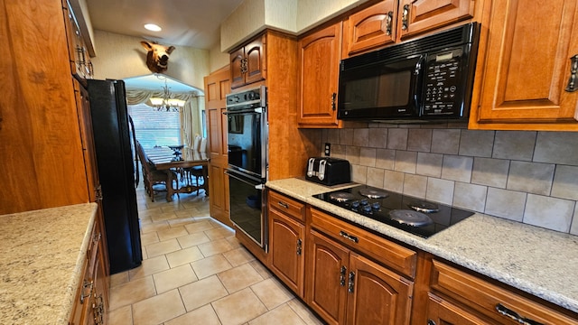 28051 Garfield St, Roseville, MI 48066 - kitchen featuring black appliances, decorative backsplash, brown cabinetry, a chandelier, and light stone counters
