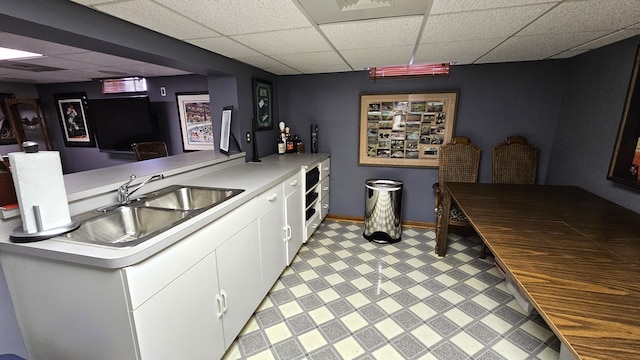 28051 Garfield St, Roseville, MI 48066 - bar with a sink, a paneled ceiling, light floors, and baseboards