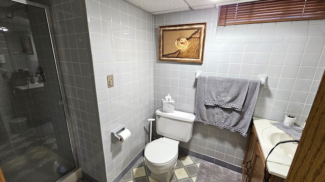 28051 Garfield St, Roseville, MI 48066 - bathroom with tile walls, a stall shower, toilet, and vanity