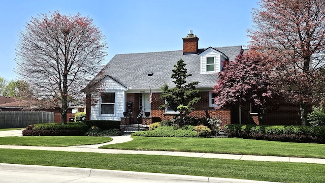 28051 Garfield St, Roseville, MI 48066 - cape cod home featuring a chimney, a shingled roof, and brick siding