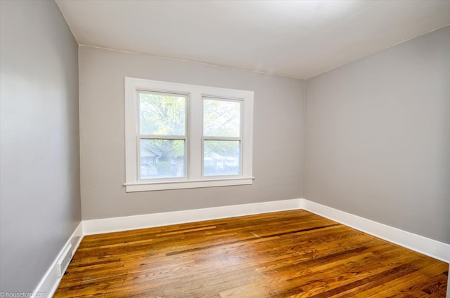 empty room with wood finished floors and baseboards