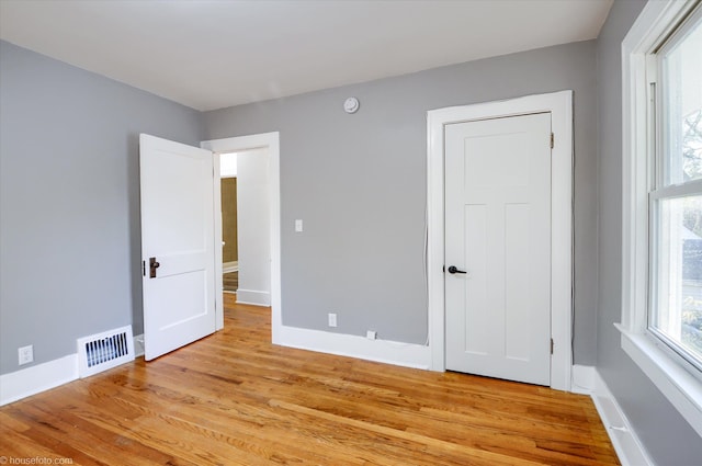 unfurnished bedroom featuring light wood finished floors and baseboards