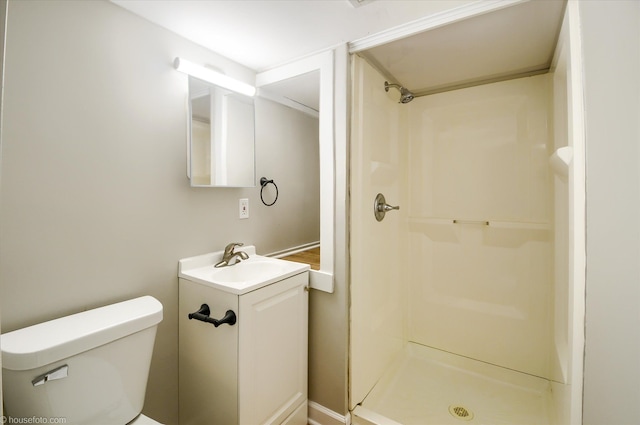 full bath with a stall shower, toilet, and vanity