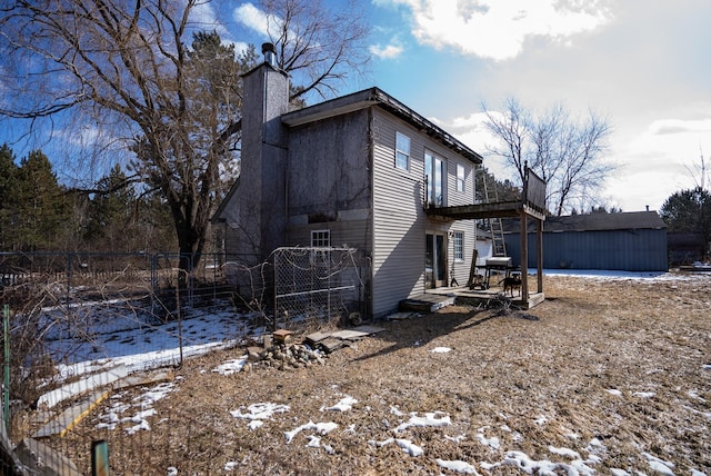 3110 Sigma Rd, Kalkaska, MI 49646 - snow covered property featuring a chimney and fence