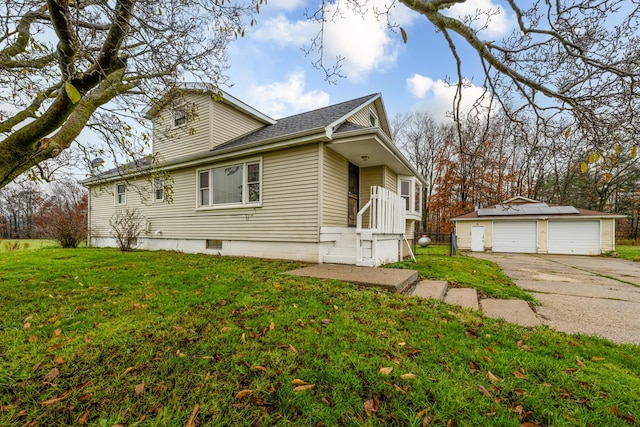 5189 W US Highway 12, Three Oaks, MI 49128 - view of side of home featuring a garage, an outdoor structure, a lawn, and roof with shingles