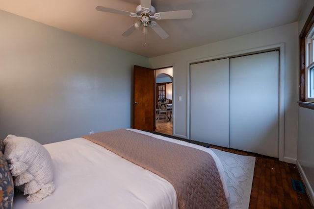 5189 W US Highway 12, Three Oaks, MI 49128 - bedroom with arched walkways, hardwood / wood-style floors, baseboards, ceiling fan, and a closet