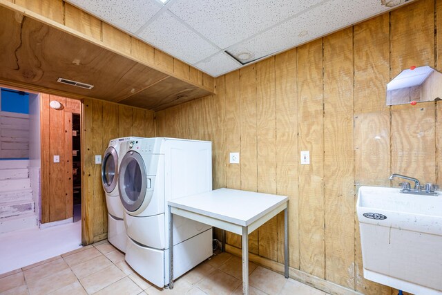 5189 W US Highway 12, Three Oaks, MI 49128 - laundry room with wood walls, independent washer and dryer, and light tile patterned flooring