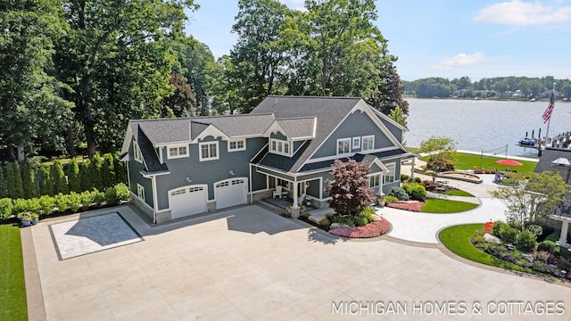 229 Norwood Ave, Holland, MI 49424 - view of front of house featuring a garage, a water view, driveway, stone siding, and a shingled roof