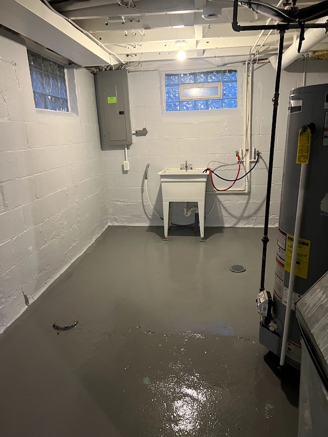 unfinished below grade area featuring electric panel, water heater, and a sink