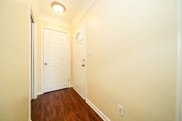 doorway to outside featuring dark wood-style floors and baseboards