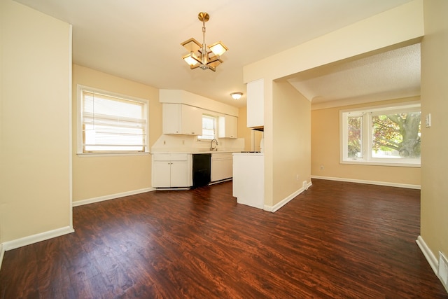kitchen featuring a chandelier, dark wood-style flooring, a sink, and white cabinets