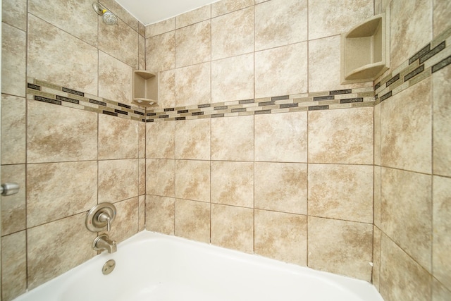 bathroom view of shower / tub combination