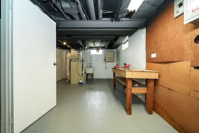 below grade area featuring a sink and heating unit
