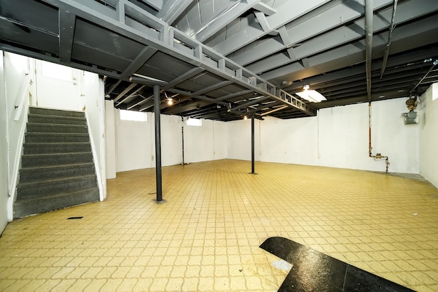 finished below grade area with tile patterned floors and stairway