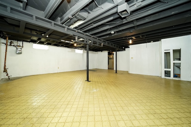 basement with tile patterned floors and gas meter