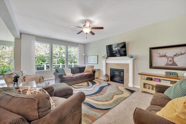 1060 Tinley Blvd, Oxford, MI 48371 - living area with carpet floors, a tile fireplace, plenty of natural light, and a ceiling fan