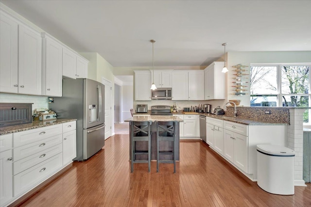 1060 Tinley Blvd, Oxford, MI 48371 - kitchen featuring appliances with stainless steel finishes, tasteful backsplash, dark wood finished floors, and white cabinets