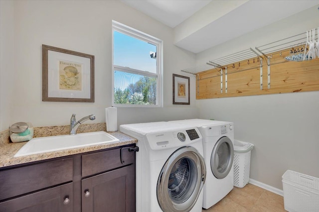 1060 Tinley Blvd, Oxford, MI 48371 - washroom with washer and clothes dryer, cabinet space, baseboards, and light tile patterned floors