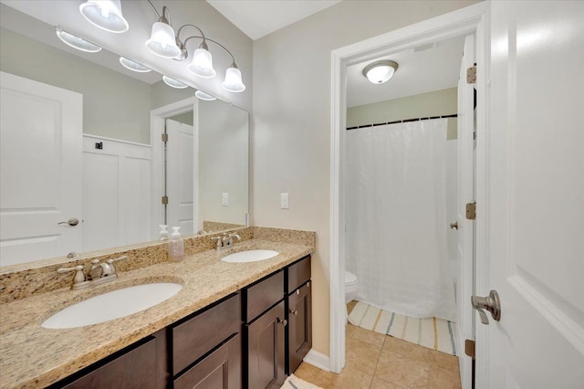 1060 Tinley Blvd, Oxford, MI 48371 - full bath featuring double vanity, toilet, tile patterned floors, and a shower with curtain