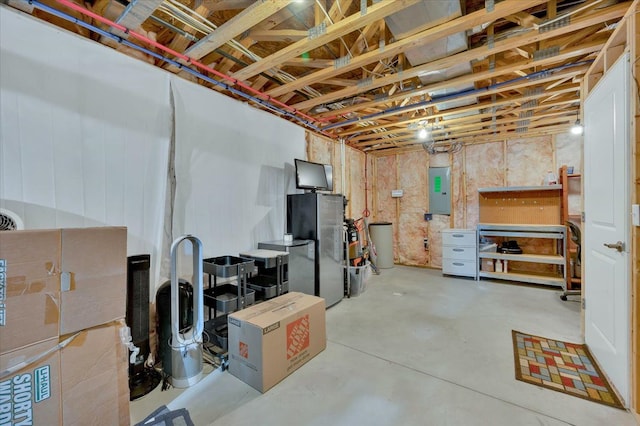 1060 Tinley Blvd, Oxford, MI 48371 - unfinished below grade area with freestanding refrigerator and electric panel
