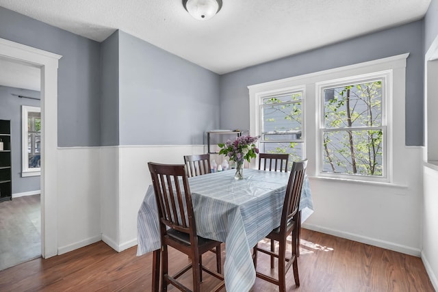 dining area featuring wood finished floors and baseboards