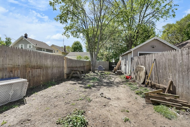fenced backyard featuring a garage