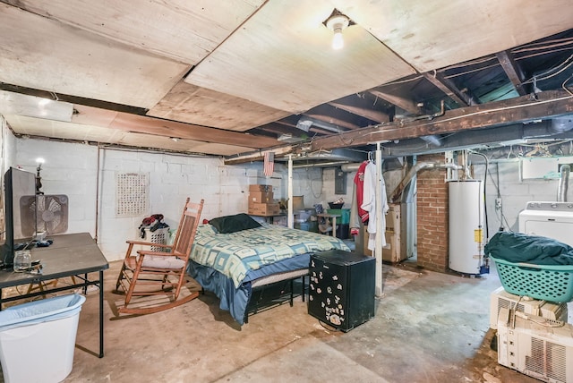 unfinished basement featuring gas water heater and washer / dryer