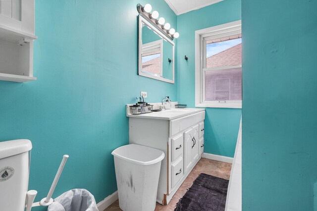 bathroom featuring vanity, toilet, and baseboards