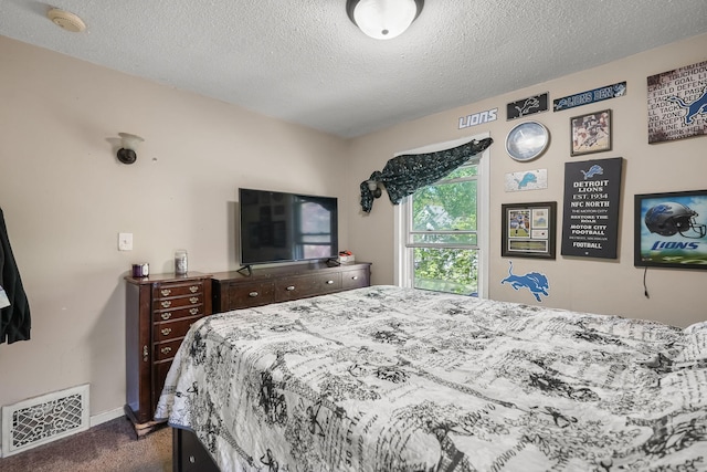 bedroom with dark carpet, a textured ceiling, and baseboards