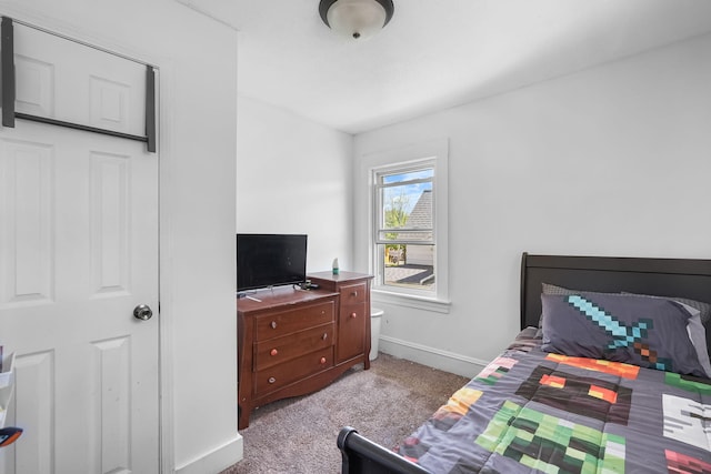 carpeted bedroom featuring baseboards
