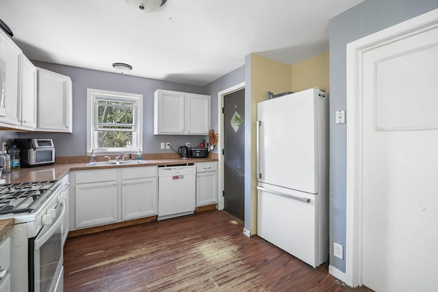 kitchen featuring white appliances, a sink, white cabinetry, and dark wood-style floors