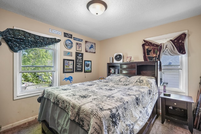 carpeted bedroom featuring baseboards and a textured ceiling