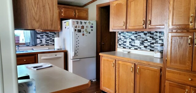 700 S Arent Rd, Watervliet, MI 49098 - kitchen with white appliances, tasteful backsplash, light countertops, and brown cabinetry