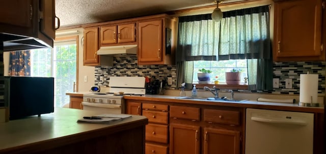 700 S Arent Rd, Watervliet, MI 49098 - kitchen with white appliances, a sink, under cabinet range hood, tasteful backsplash, and light countertops
