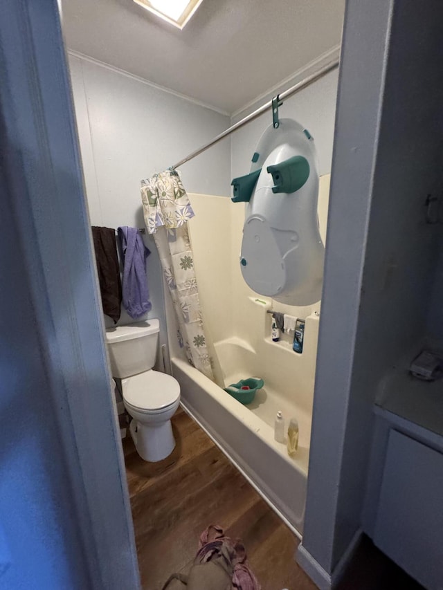 127 N Camburn St, Stanton, MI 48888 - full bath with wood finished floors, shower / bathtub combination with curtain, and toilet