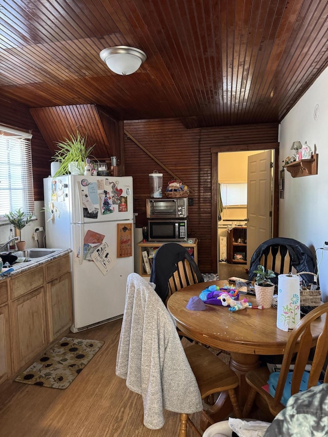 127 N Camburn St, Stanton, MI 48888 - dining area with wooden ceiling, wood finished floors, and wood walls