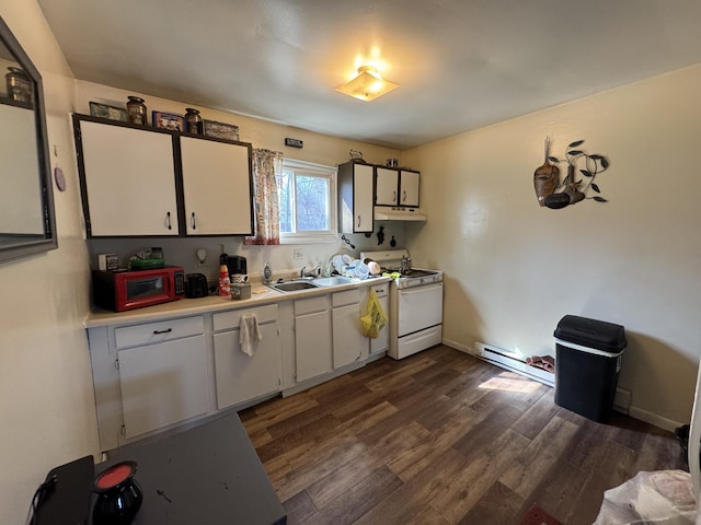 190 E Sidney Rd, Stanton, MI 48888 - kitchen with white gas range, a baseboard radiator, under cabinet range hood, white cabinets, and light countertops
