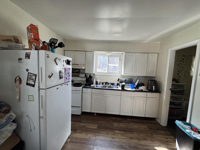 190 E Sidney Rd, Stanton, MI 48888 - kitchen featuring white appliances, dark wood finished floors, a sink, white cabinetry, and dark countertops