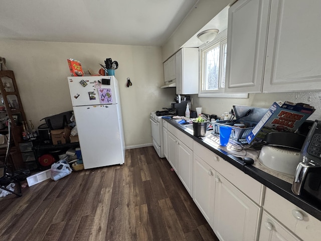 190 E Sidney Rd, Stanton, MI 48888 - kitchen with white appliances, dark wood-style floors, white cabinets, and under cabinet range hood