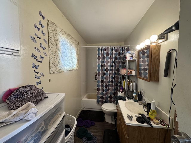 190 E Sidney Rd, Stanton, MI 48888 - full bath with vanity, toilet, shower / tub combo with curtain, vaulted ceiling, and wood finished floors